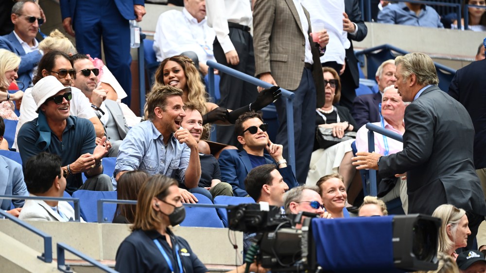 Alec Baldwin speaks with Brad Pitt, Bradley Cooper and Rami Malek during the Men's Singles championship match at the 2021 US Open, Sunday, Sep. 12, 2021 in Flushing, NY. (Garrett Ellwood/USTA via AP)