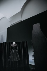 A Christian Dior New York dress from the 1950s in front of a 1946 Charles Eames screen and the 1956 “First Personage” sculpture by Louise Nevelson.