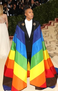 Actress Lena Waithe on the red carpet in a pride cape over a suit designed by Wes Gordon to The Metropolitan Museum of Arts Costume Institute Benefit on May 7, 2018.