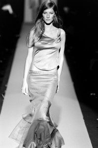 Model Gisele Bundchen on the runway in an ensemble from designer Carolina Herrera's spring 2000 ready to wear collection.