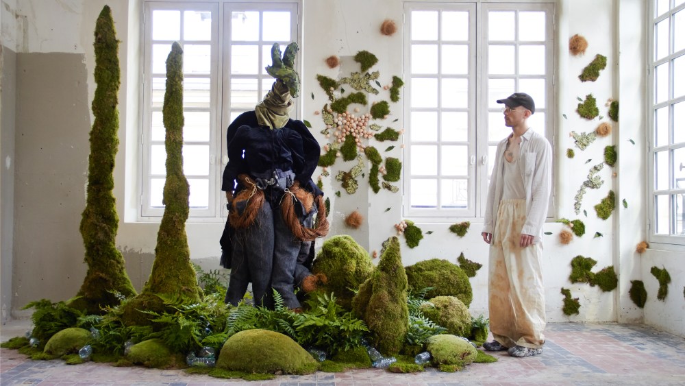 Pierre-Alexandre Fillaire in front of a tableau from the Land Full exhibition, designed in collaboration with floral design studio Nue Paris's founder Claire Boreau.