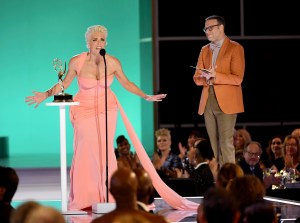 Hannah Waddingham accepts the award for outstanding supporting actress in a comedy series for "Ted Lasso" and Seth Rogan looks on at the 73rd Emmy Awards on Sunday, Sept. 19, 2021 at the Event Deck at L.A. LIVE in Los Angeles. (Photo by Phil McCarten/Invision for the Television Academy/AP Images)