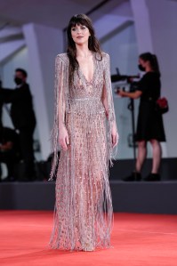 Dakota Johnson poses for photographers upon arrival at the premiere of the film 'The Lost Daughter' during the 78th edition of the Venice Film Festival in Venice, Italy, Friday, Sep, 3, 2021. (AP Photo/Domenico Stinellis)