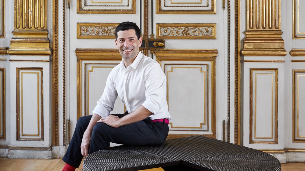 Alexis Mabille with a table from his debut furniture line.