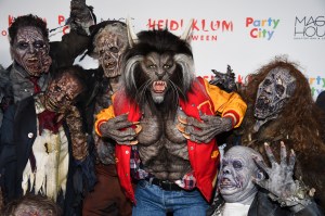 Model Heidi Klum, center, dressed as a werewolf from Michael Jackson's "Thriller" video poses on the carpet at her 18th Annual Halloween Party at Moxy Times Square on Tuesday, Oct. 31, 2017, in New York. (Photo by Evan Agostini/Invision/AP)