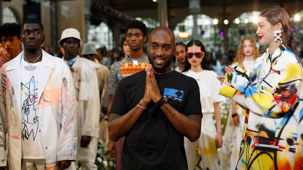 Designer Virgil Abloh, centre, accepts applause as he poses with other models including Gigi Hadid, right, at the conclusion of the Off White mens Spring-Summer 2020 fashion collection presented in Paris, Wednesday, June 19. (AP Photo/Thibault Camus)