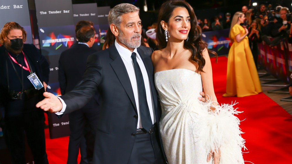 George Clooney and Amal Clooney pose for photographers upon arrival at the premiere of the film 'The 'Tender Bar' during the 2021 BFI London Film Festival in London, Sunday, Oct. 10, 2021. (Photo by Joel C Ryan/Invision/AP)