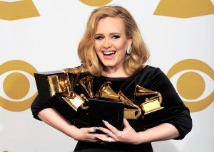 FILE - In this file photo dated Sunday, Feb. 12, 2012, Adele poses backstage with her six awards at the 54th annual Grammy Awards on Sunday, Feb. 12, 2012 in Los Angeles, USA.  According to figures released Tuesday April 12, 2016, Adele had the world's best-selling album last year, as the British singer's "25" sold 17.4 million copies. (AP Photo/Mark J. Terrill, FILE)