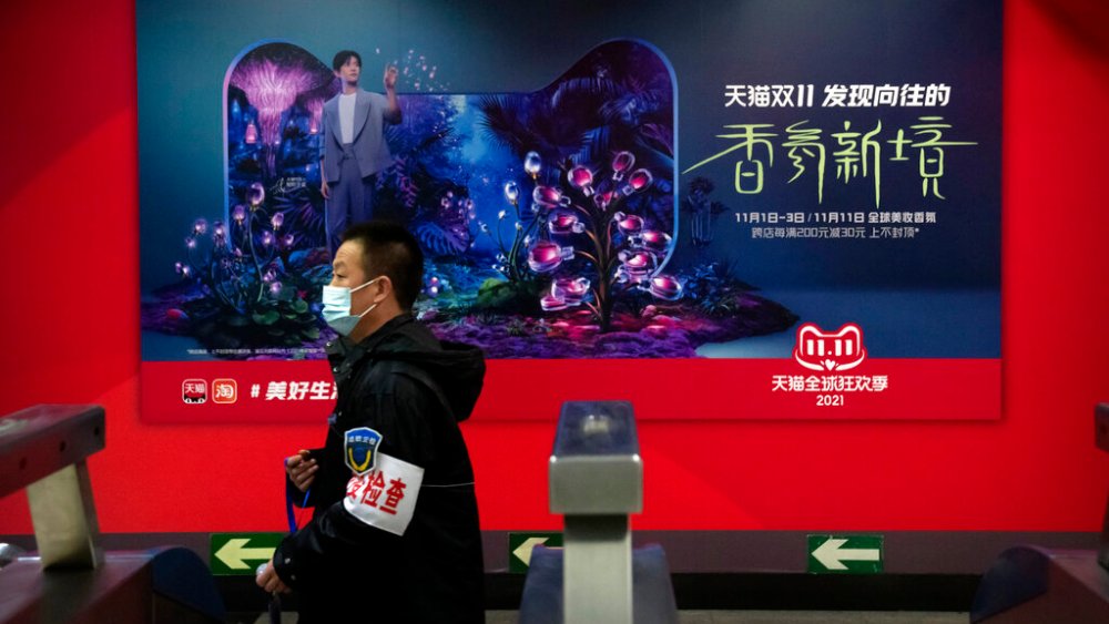 A man walks past an advertisement for Alibaba's recently-wrapped Singles' Day sale.