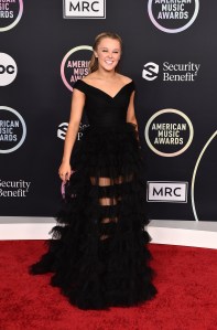 JoJo Siwa arrives at the American Music Awards on Sunday, Nov. 21, 2021, at Microsoft Theater in Los Angeles. (Photo by Jordan Strauss/Invision/AP)