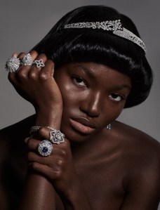 Chanel High Jewelry’s Jeanne tiara in 18-karat white gold with diamonds. On hand, from left: Wempe’s Spotlight 18-karat white gold diamond ring; Boucheron’s Wladimir, the Cat 18-karat white gold ring, set with round diamonds, one pear-cut tsavorite, round tsavorites, mother-of-pearls, quartz, black sapphires and pink lacquer, and Roberto Coin’s Dia Princess ring in 18-karat white gold and diamonds. On wrist: De Beers Jewellers’ Reflections of Nature Okvando Grace three-row bracelet set in 18-karat white gold. On hand: Buccellati’s Opera ring in 18-karat white gold set with diamonds and Chopard’s Precious Lace Collection ring featuring blue sapphires and diamonds set in 18-karat ethical white gold.