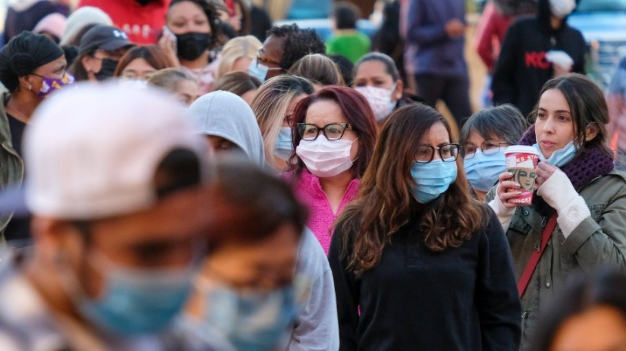 Black Friday shoppers wearing face masks wait in line to enter a store at the Citadel Outlets in Commerce, Calif., Friday, Nov. 26.