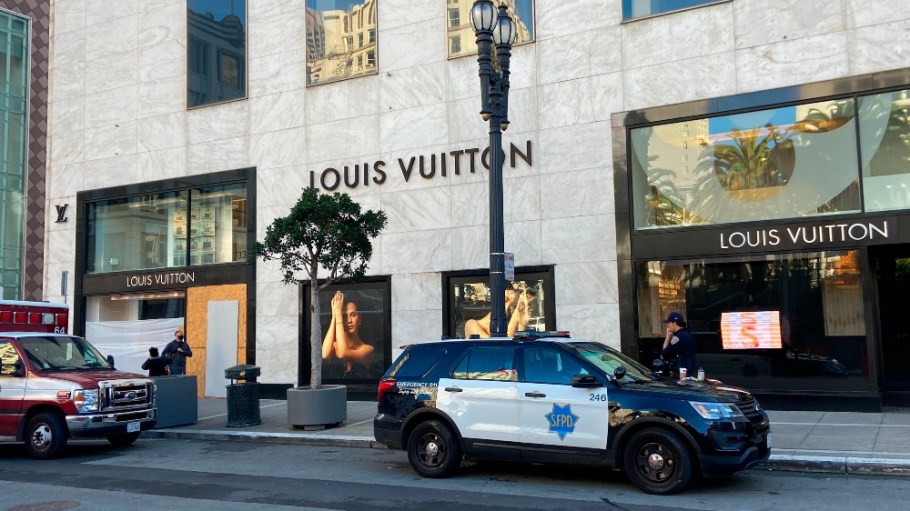 Police officers and emergency crews park outside the Louis Vuitton store in San Francisco's Union Square on Saturday.