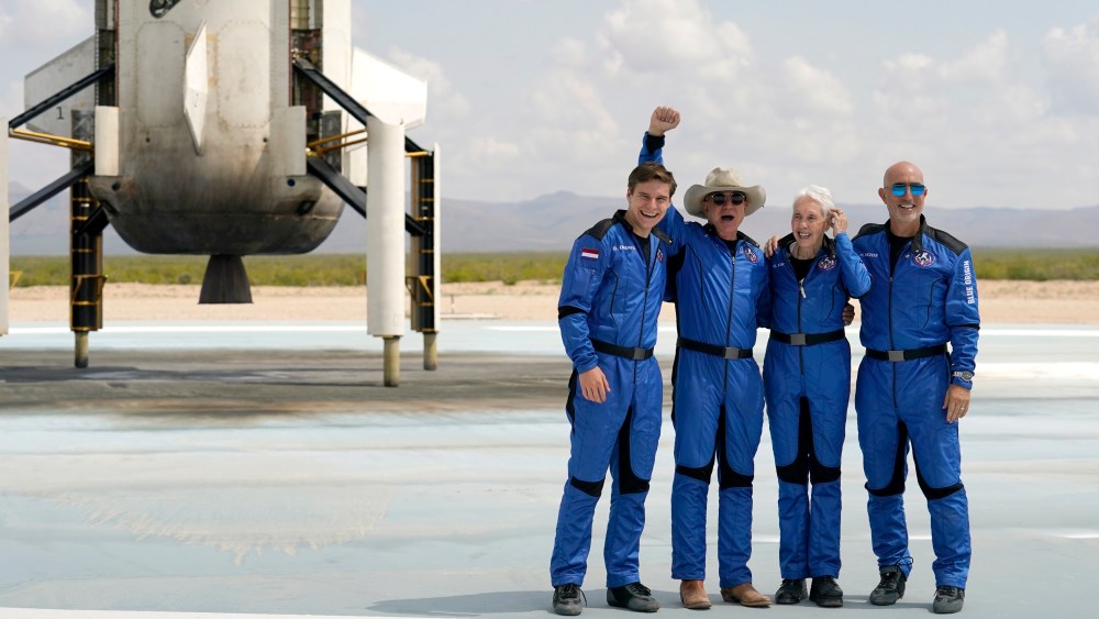 Oliver Daemen, Jeff Bezos, Wally Funk and Bezos' brother Mark in front of the Blue Origin New Shepard rocket