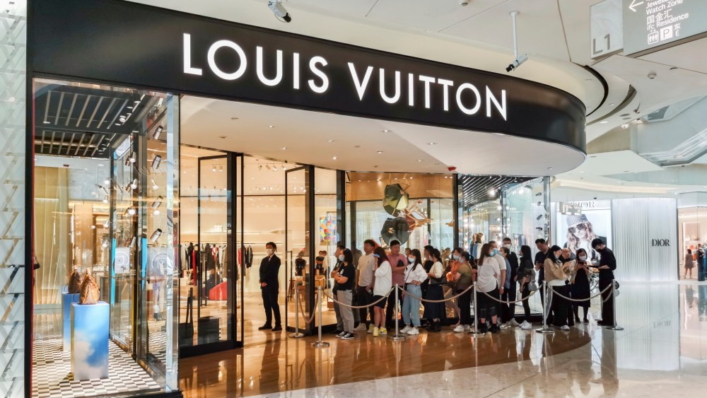 People line up in front of a Louis Vuitton store in Shanghai