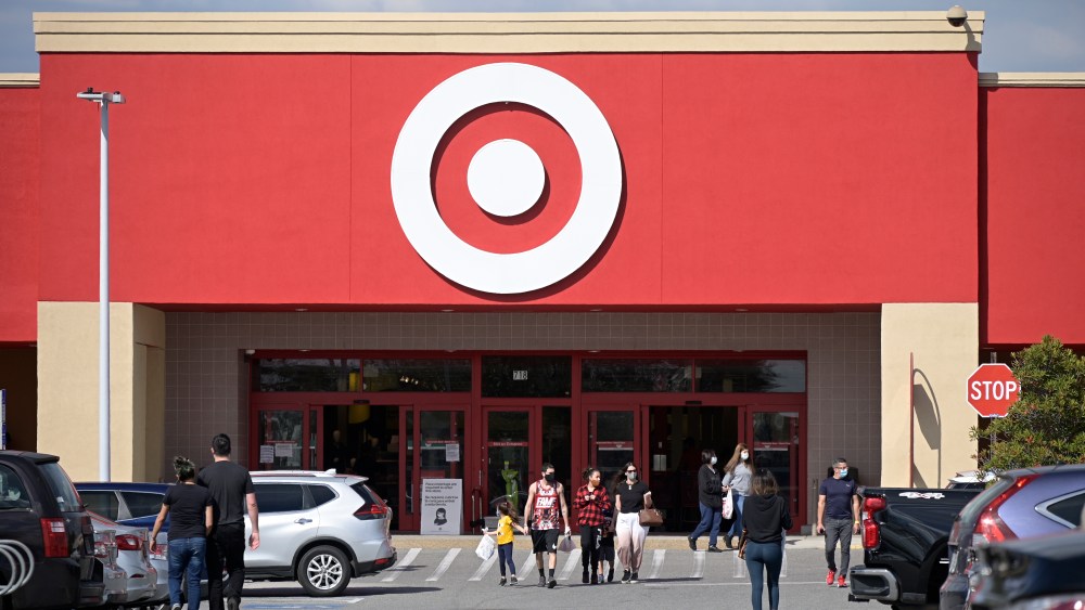 People wear face masks to help prevent the spread of COVID-19 outside a Target store during a new coronavirus pandemic, Saturday, Jan. 30, 2021, in Orlando, Fla. (Phelan M. Ebenhack via AP)
