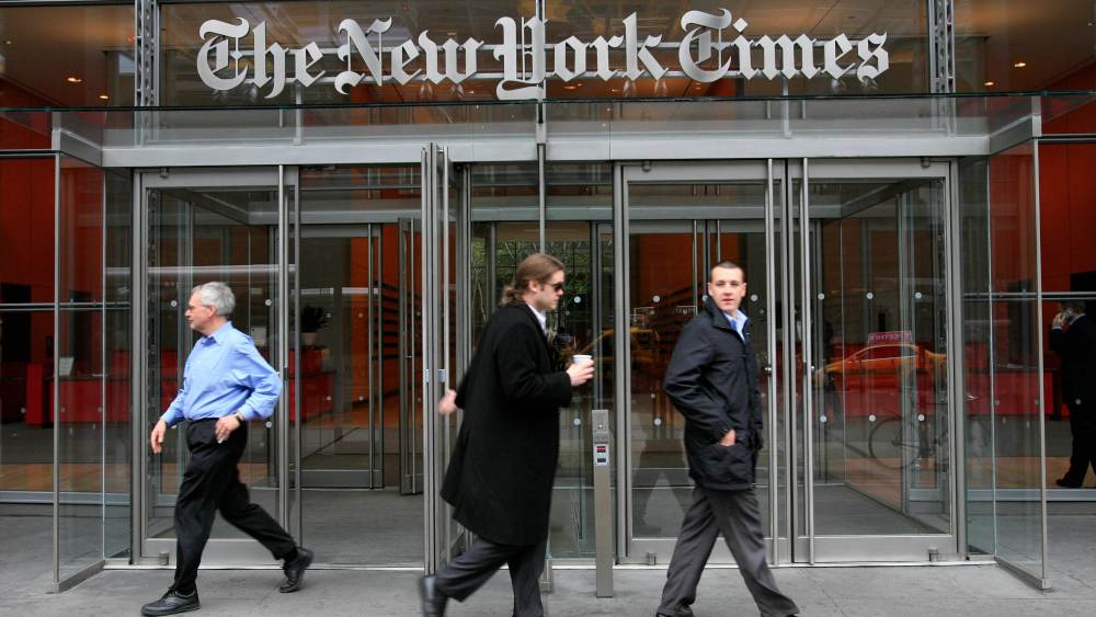 People leave The New York Times headquarters Monday, April 20, 2009 in New York. The New York Times Co. said Tuesday, its first-quarter losses worsened amid a dramatic downturn in advertising revenue at its newspapers. (AP Photo/Mark Lennihan)