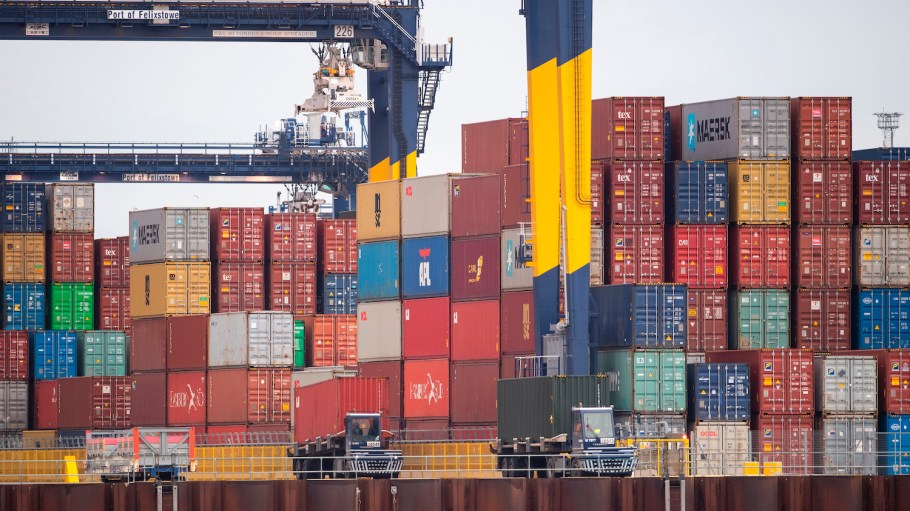 Shipping containers are unloaded from a cargo ship at the Port of Felixstowe in Suffolk, England.