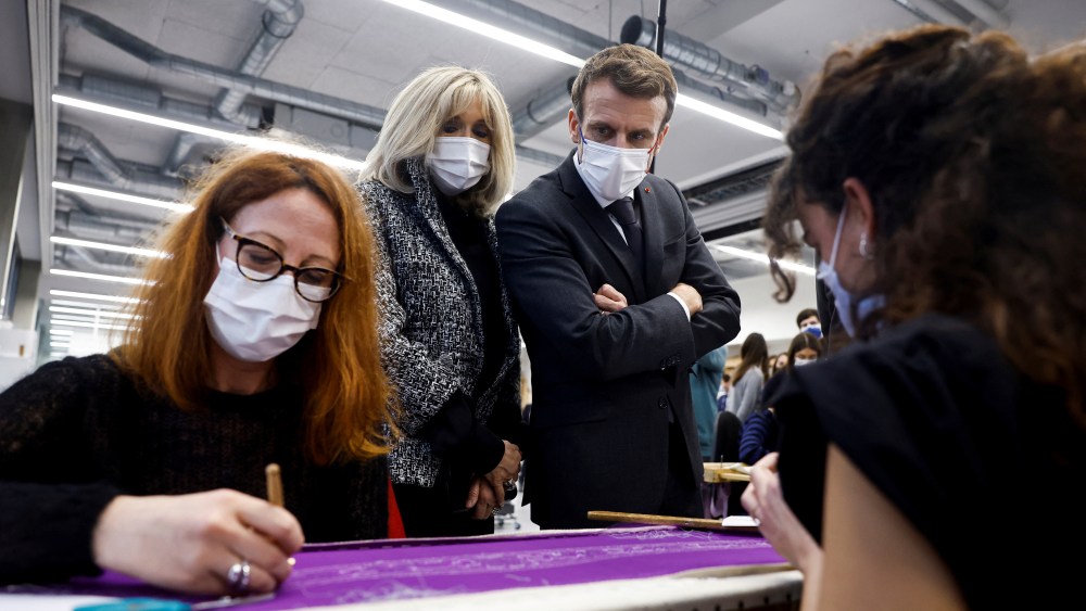 French President Emmanuel Macron, center right, and his wife Brigitte Macron visit Chanel's Metiers d'Art workshops at le 19M, the building which houses around 600 artisans, in Paris, France, Thursday, Jan. 20, 2022. (Christian Hartmann, Pool Photo via AP)