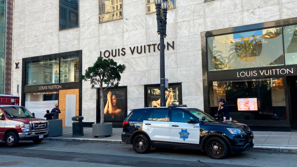 Police officers park outside the Louis Vuitton store in San Francisco's Union Square on Nov. 21, 2021, after looters ransacked businesses.