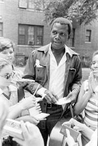 Sidney Poitier signs autographs during the third annual Robert F. Kennedy Pro-Celebrity Tennis Tournament at Forest Hills Stadium in New York City on August 24, 1974.