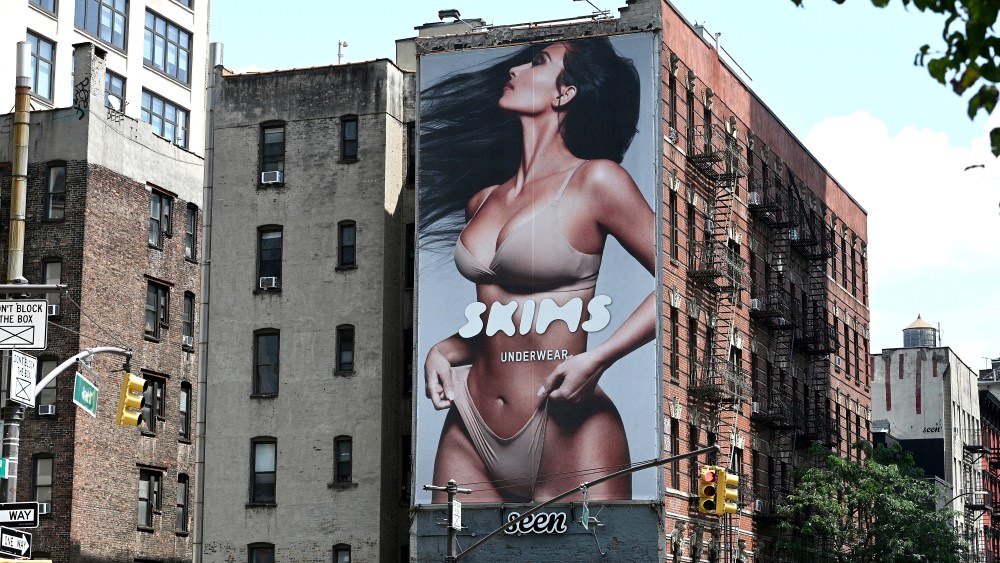 A view of "SKIMS" shapewear brand advertising featuring Kim Kardashian, seen on 6th Avenue in New York, NY, July 16, 2021. The image featuring Kim Kardashian has been criticized for appearing "photoshopped" or digitally manipulated to enhance the effect of the product. (Photo by Anthony Behar/Sipa USA)(Sipa via AP Images)