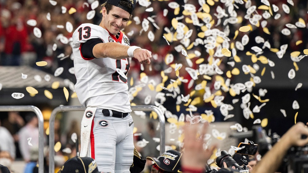 INDIANAPOLIS, IN - JANUARY 10: Georgia Bulldogs QB Stetson Bennett (13) celebrates on the stage after the Alabama Crimson Tide versus the Georgia Bulldogs in the College Football Playoff National Championship, on January 10, 2022, at Lucas Oil Stadium in Indianapolis, IN. (Photo by Zach Bolinger/Icon Sportswire) (Icon Sportswire via AP Images)