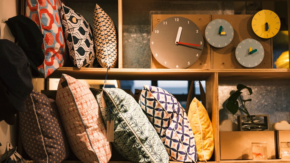 Pillows and handmade clocks in an elegant shop