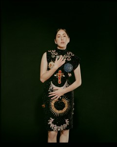 Schiaparelli haute couture’s sleeveless dress embroidered with allover trompe l'oeil jewelry composed of Swarovski jet rhinestones, enhanced with trompe l’oeil necklaces made from vintage stones, pearls and Swarovski rhinestones.