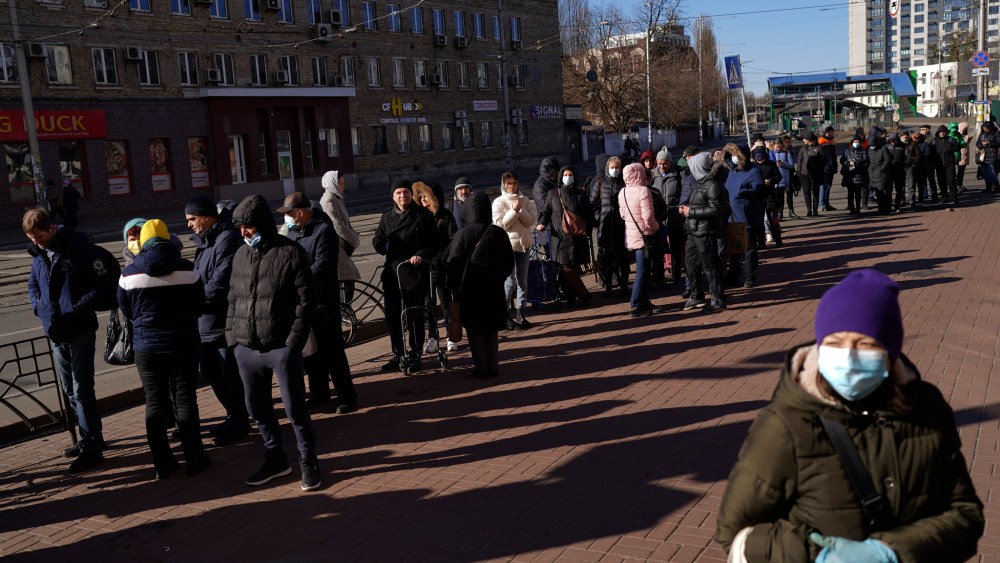 People wait in line outside a supermarket in central Kyiv, Ukraine, Feb. 28, 2022.
