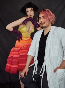 Bach Mai: Deep V Strapless Sculptural Volant Dress in "Strawberry Lemonade" Mille Feuille Raw Edged Chiffon Strips worn with Aubergine Leather Gloves from Wing and Weft Gloves.