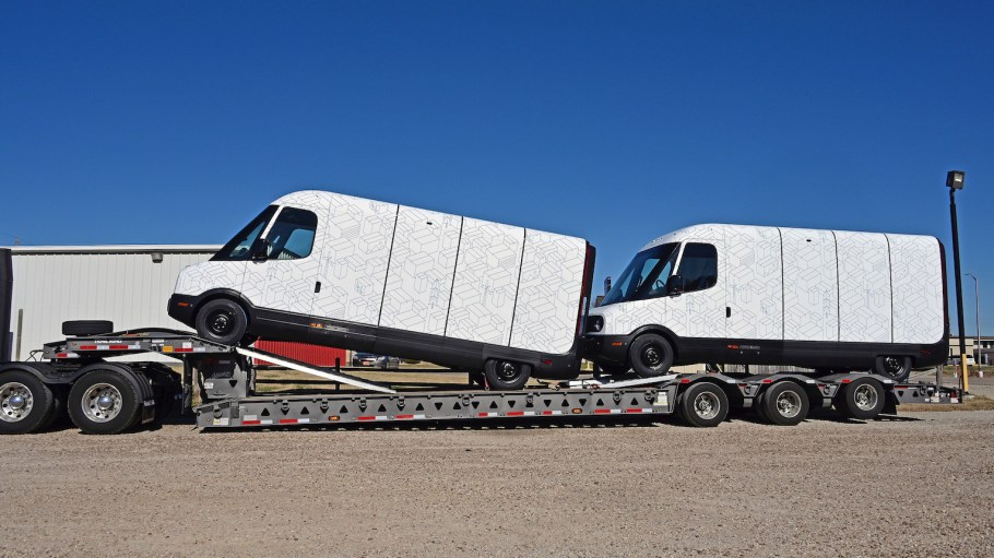 Two brand new model EDV 500 Rivian Electric Delivery Vans (EDV), part of the fleet order for Amazon on the back of a transportation lowboy truck parked in the Knights Inn Motel while traveling from the production plant in Normal, Ill. to their final destination on Nov. 21, 2021, in Emporia, Kan.