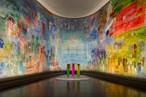 Yves Saint Laurent designs in front of Raoul Dufy’s “The Electricity Fairy” at the Paris Museum of Modern Art.