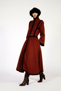 A model in a black trimmed cossack coat from Yves Saint Laurent's RTW Fall 1976 "Big Fantasy" collection.