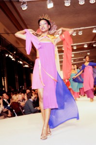 Mounia Orsemane on the runway in a tri-color pleated evening dress from Yves Saint Laurent's "High Seas Chic" RTW Spring 1978 collection in Paris.