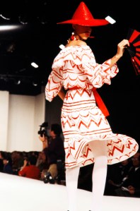 Pat Cleveland poses on the runway in a red and white graphic print dress from the YSL RTW Spring 1980 collection.