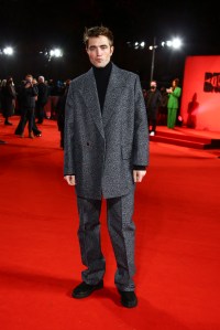 Robert Pattinson poses for photographers upon arrival for the screening of the film 'The Batman' in London Wednesday, Feb. 23, 2022. (Photo by Joel C Ryan/Invision/AP)