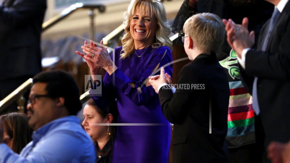 First lady Jill Biden applauds as she looks to Joshua Davis of Midlothian, Va., as President Joe Biden arrives to deliver his first State of the Union address to a joint session of Congress at the Capitol, Tuesday, March 1, 2022, in Washington. (Julia Nikhinson/Pool via AP)