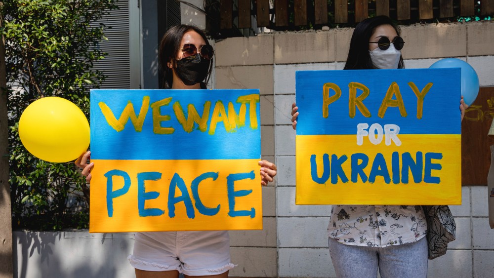 Protesters hold placards during a demonstration against the Russian attack on Ukraine in front of the Russian Embassy in Bangkok.