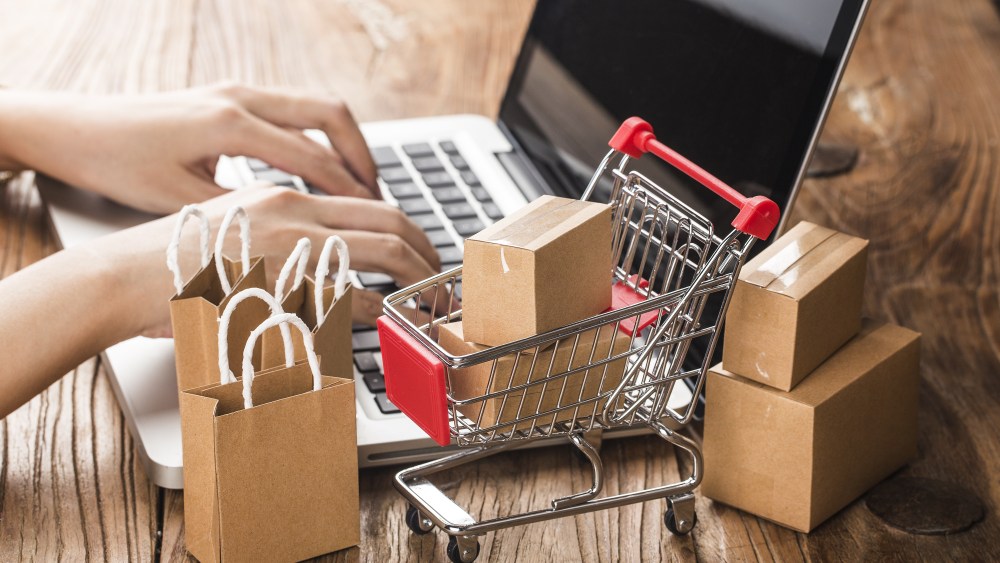 shopping online at home concept.Cartons in a shopping cart on a laptop keyboard