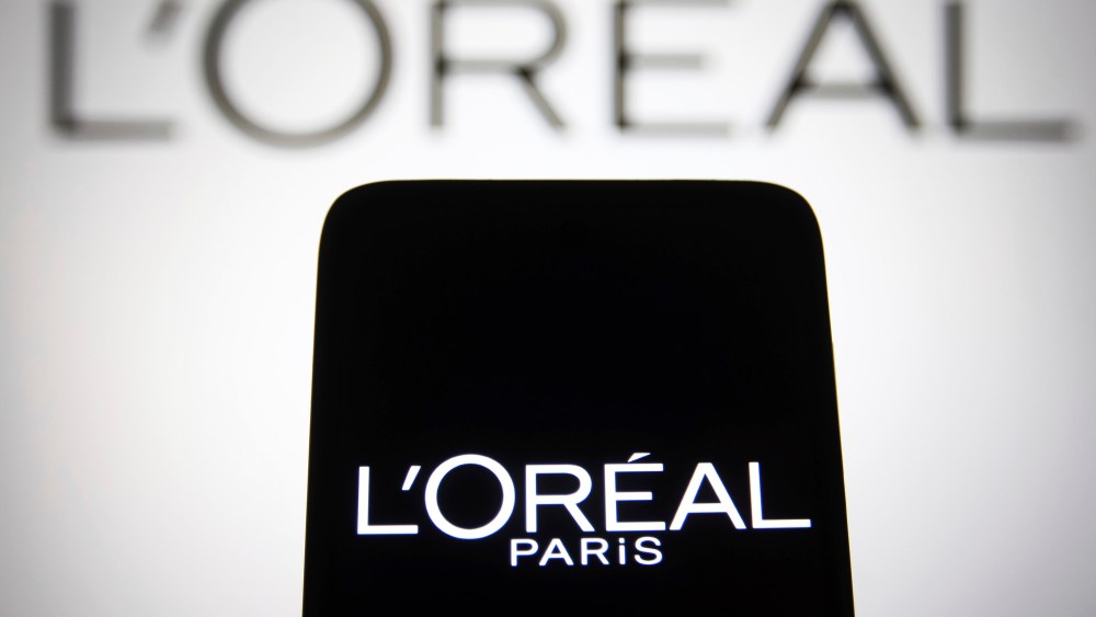 In this photo illustration, L'Oreal S.A. logo seen on a smartphone and a pc screen. (Photo by Pavlo Gonchar / SOPA Images/Sipa USA)(Sipa via AP Images)