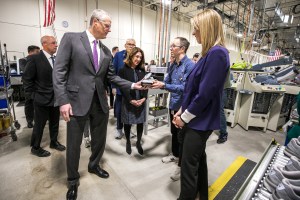 Massachusetts Governor Charlie Baker (left), Lieutenant Governor Karyn Polito (back middle) and Congresswoman Lori Trahan (right) get a tour of New Balance's Methuen facility.