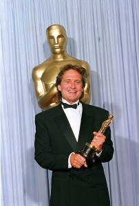Actor Micheal Douglas poses with his Oscar in front of a life-size model of the statuette at the 60th Annual Academy Awards in Los Angeles, Ca., Monday night on April 11, 1988.  Douglas won best actor for his role in "Wall Street."  (AP Photo/Lennox McLendon)
