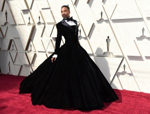 FILE - This Feb. 24, 2019 file photo shows Billy Porter wears a black velvet tuxedo gown by Christian Siriano at the Oscars in Los Angeles. (Photo by Richard Shotwell/Invision/AP, File)
