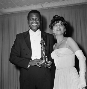 Sidney Poitier was named best actor of the year for 1964 for his role in  "Lilies of the Field,"  awarded by actress Anne Bancroft, at right, at ceremonies in Santa Monica, Calif. on April 13, 1964.  The award was presented by  the Motion Picture Academy.  (AP Photo)