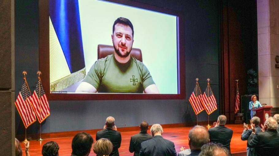 Members of Congress give Ukraine President Volodymyr Zelensky a standing ovation before he speaks in a virtual address to Congress in the U.S. Capitol Visitors Center Congressional Auditorium in Washington, Wednesday, March 16, 2022.