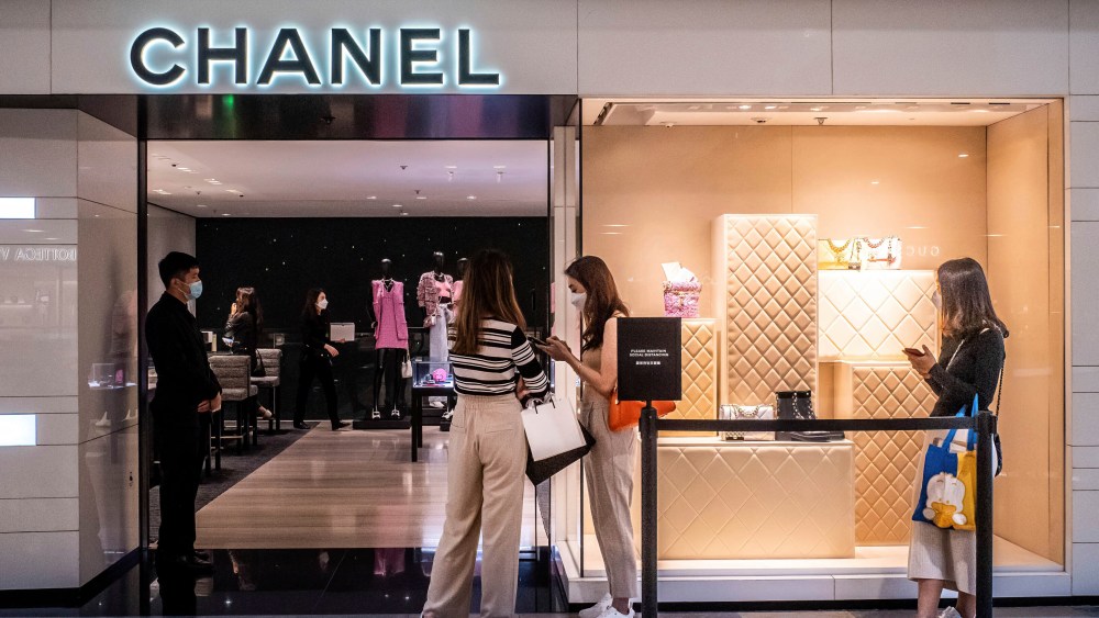 Shoppers wearing surgical masks abide by social distancing measures and queue to enter a Chanel store in the Admiralty district of Hong Kong.