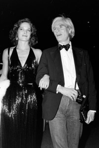 Barbara Allen and Andy Warhol attend the Metropolitan Museum Costume Institute "Vanity Fair: A Treasure Trove" exhibition and gala in New York City on December 12, 1977.