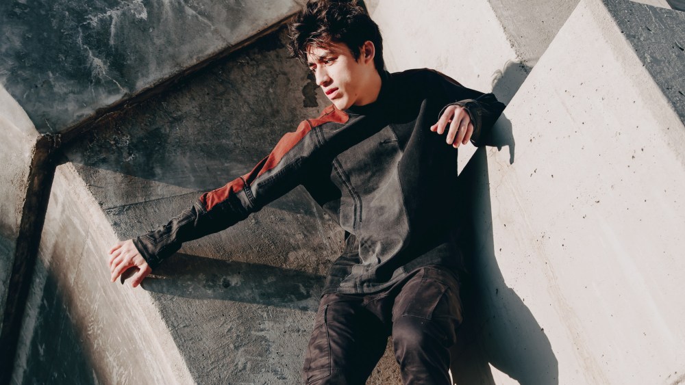A model shows off an upcycled denim sweatshirt created by Preston Sanchez.