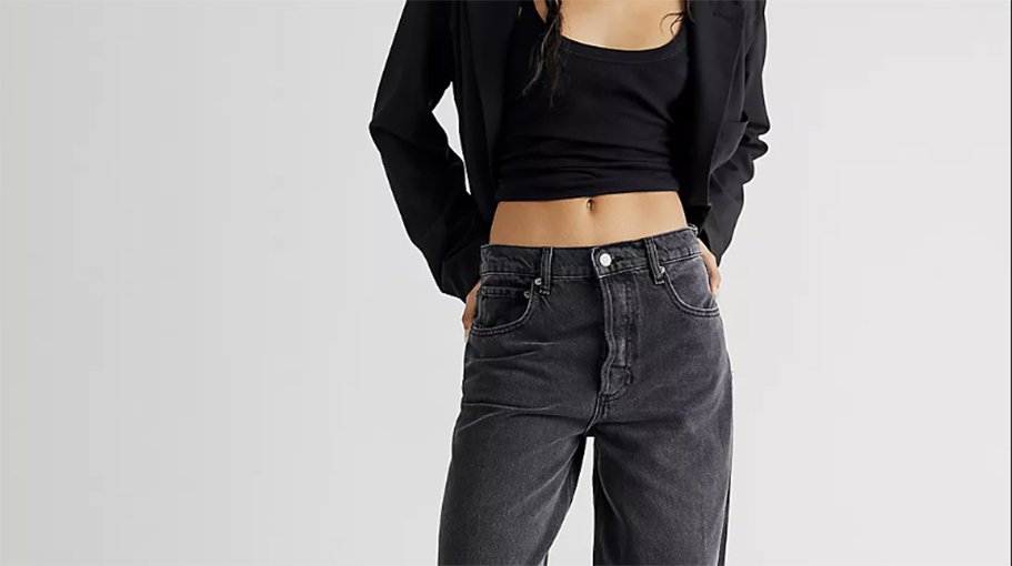 Woman standing in wide leg jeans